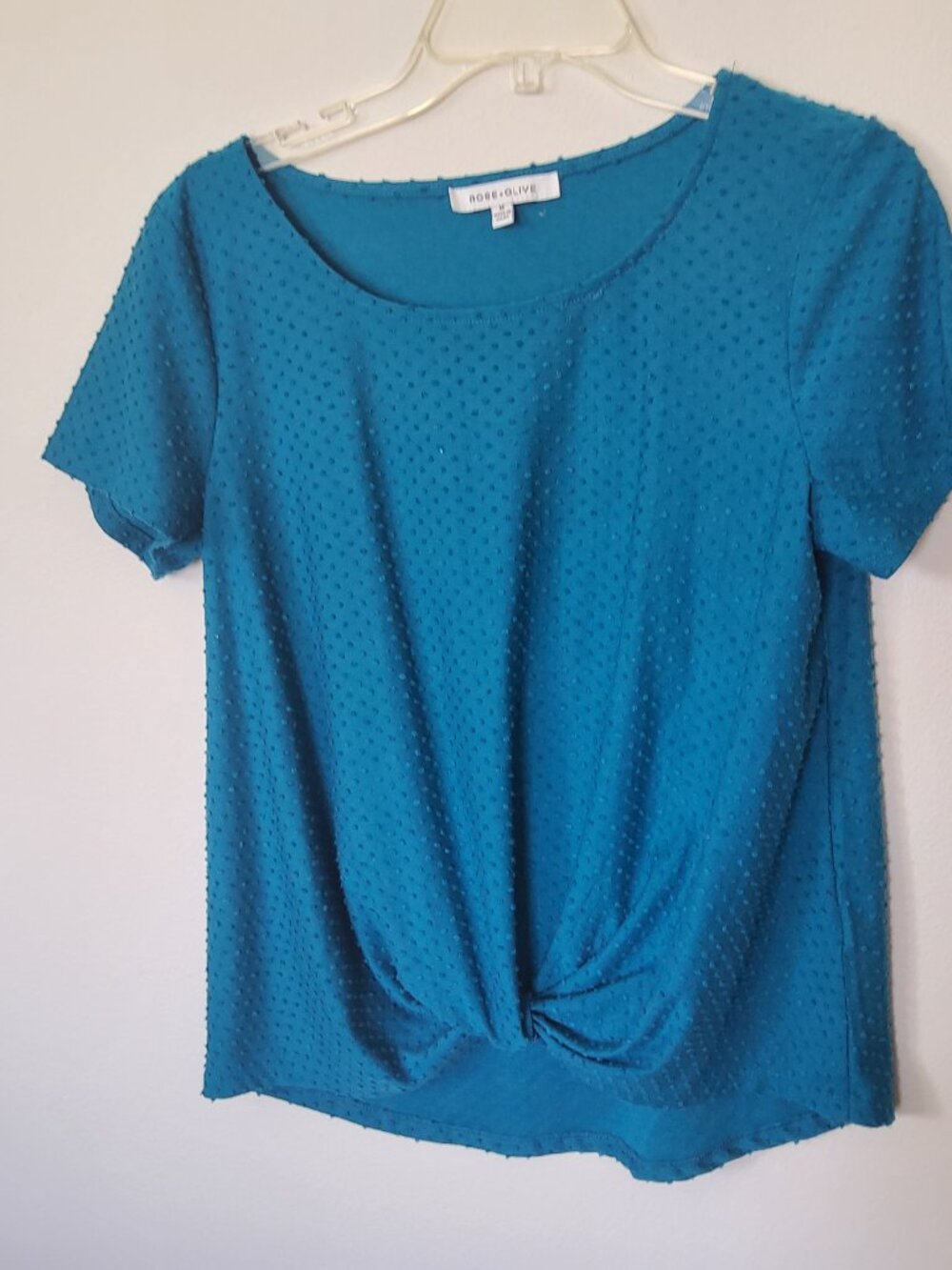 Teal dot patterned top with twist front size M